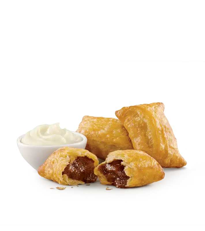 Warm Cinnabon Cinnasnacks served with rich cream cheese frosting for a sweet Sonic treat.